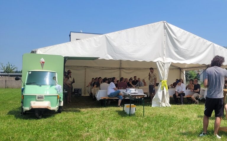 The tent at the summer party with a ice cream truck on the left