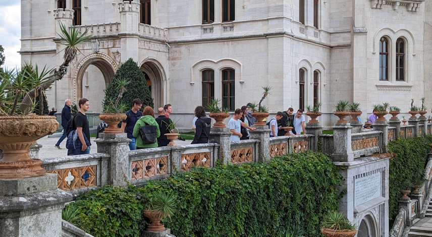 Employees stand in front of a historic building